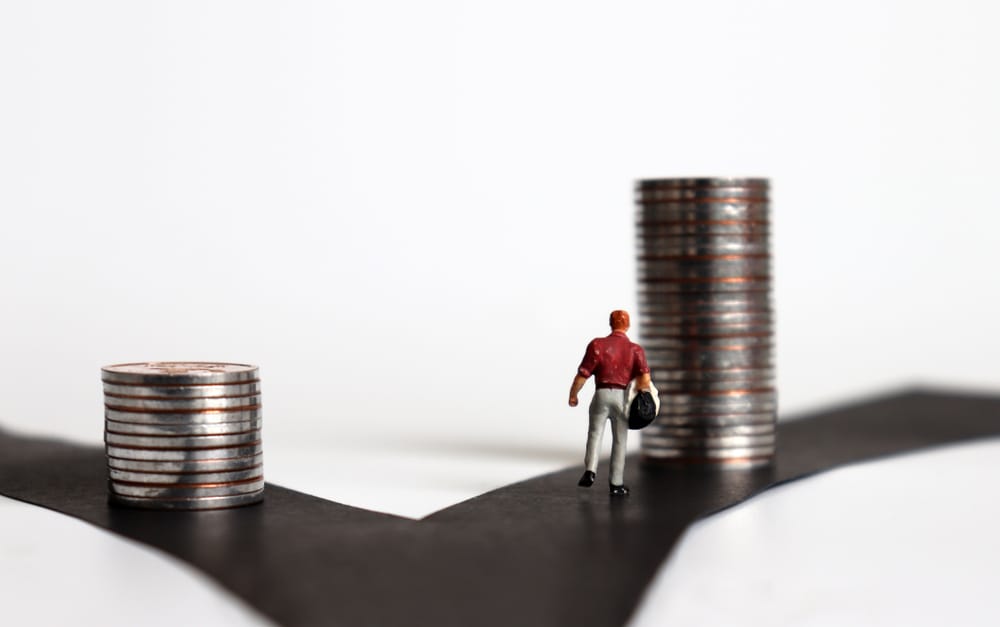 Person standing at a fork in the road, symbolising the choice between Cash ISA and Stocks & Shares ISA options in 2025