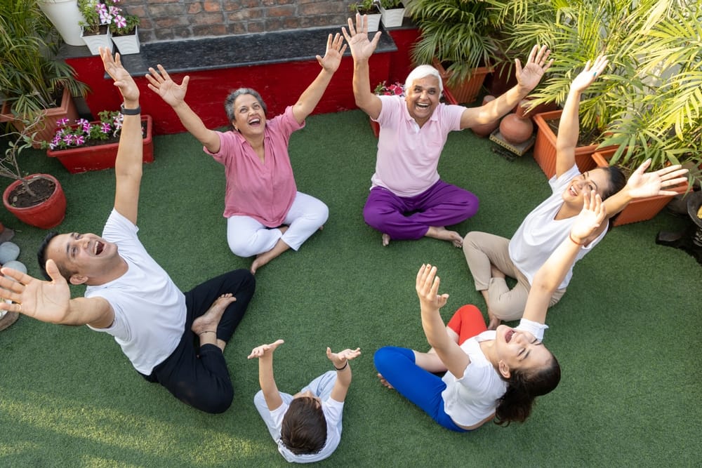 Multigenerational family doing yoga together, representing family wealth planning and inheritance tax planning across generations